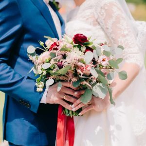 bride and groom holding wedding bouquet